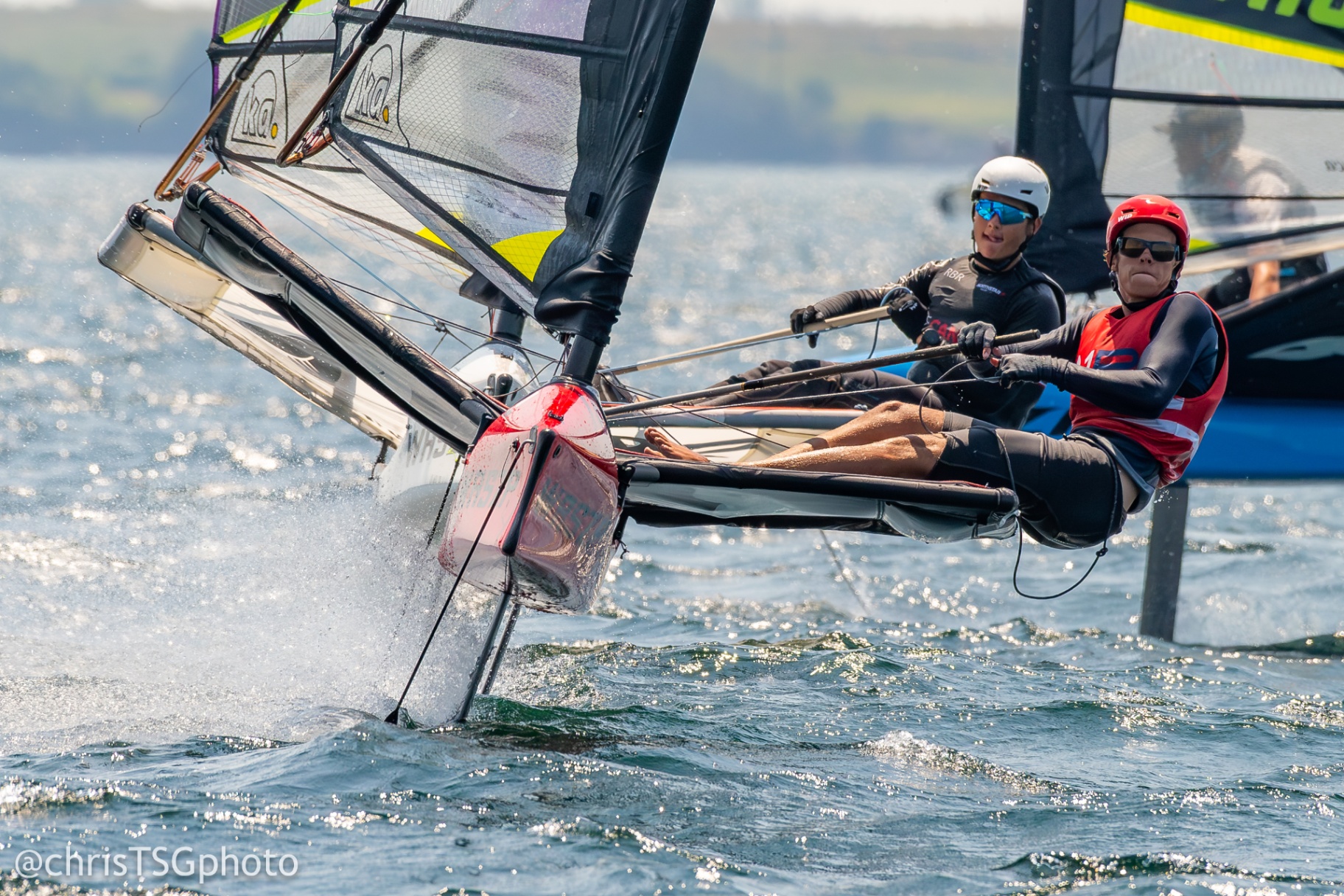 Foiling sailor hiking off the rack at speed